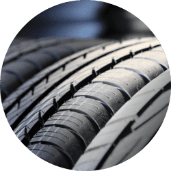 Close-up view of multiple car tires showcasing tread patterns, emphasizing durability and performance for automotive applications.
