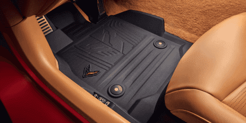 Close-up view of a sleek red sports car showcasing its rear engine cover, featuring a distinctive design and vent details that enhance aerodynamics and performance.